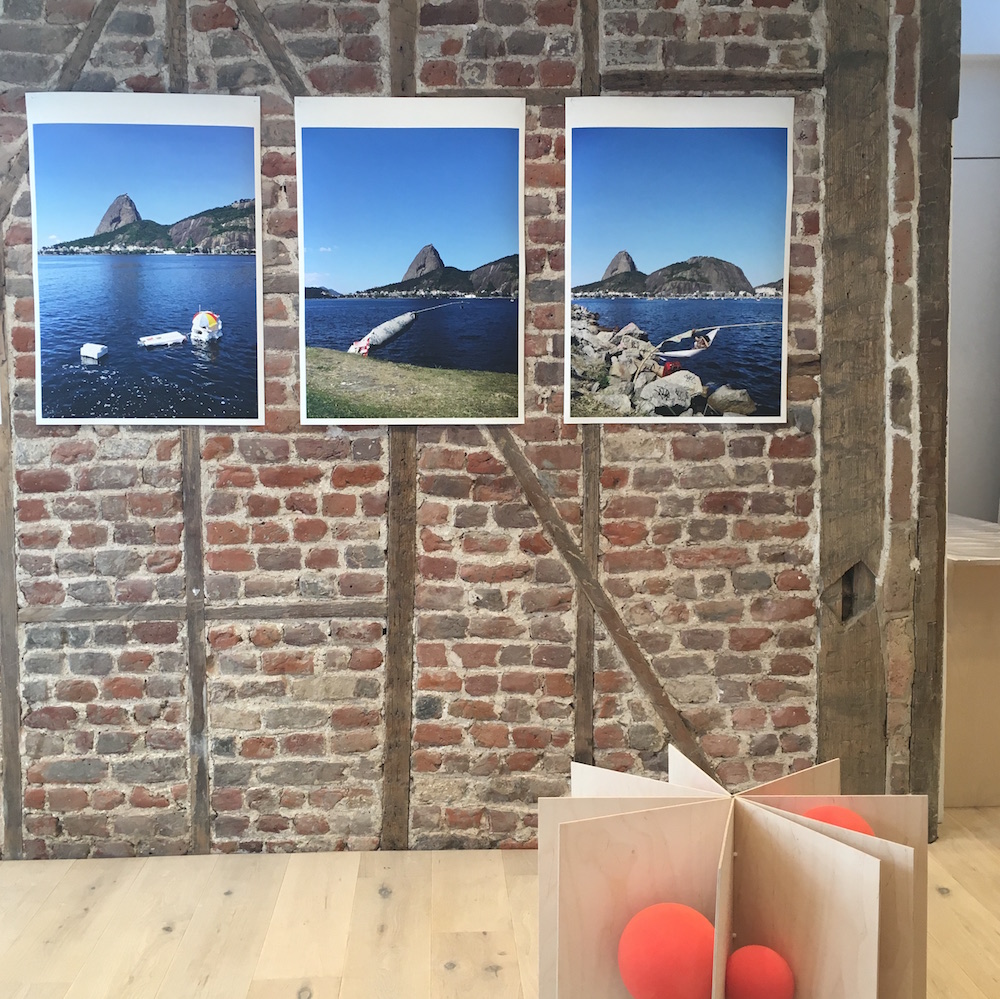 3 coloured landscape photos of Rio by Marcos Chaves on the brick gallery wall
