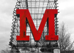 Large red M on gabion cage