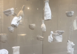 installation in the windows of One Paved Court using stitched soft sculpture ‘vessels’ - bowls, cups, bottles, a jug and a teapot made from felted wool blankets covered with vintage linen and damask