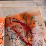 sketch book with orange abstract painting with indian block printing textures